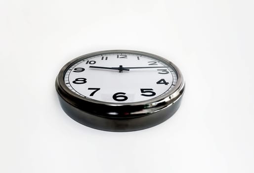 Analog clock with the hands hanging on a white wall seen from below. Time concept. Hurry and deadlines.