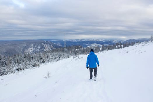Man walking on snow covered mountain, Rax, Austria