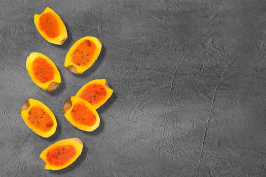 Flying yellow cut in half prickly pear cactus fruits on creative trendy background. Food levitation concept. Flat lay with copy space.