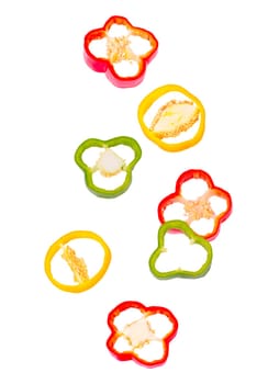 Isolated vegetables. Seven mixed pieces of bell pepper in the air on white with clipping path as package design element. Full depth of field. Food levitation concept.