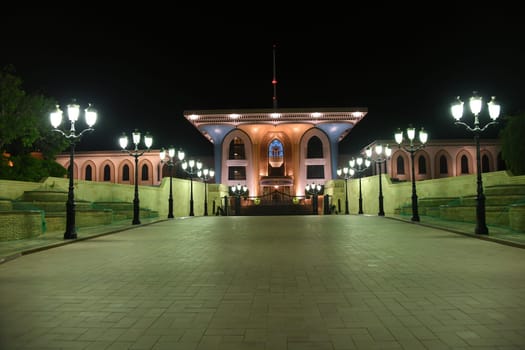 The historical landmark of the Sultan's Palace,also called the Flag Palace,in the of the old town of Muscat at night and lanterns was built in the Anglo-Indian style.