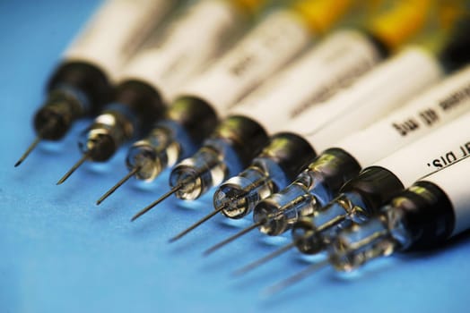 Syringes on a blue background in a hospital