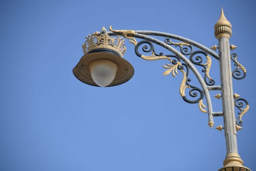 An electric metal street lamp in Ottoman,oriental style on the waterfront in the port city of Sur in Oman.