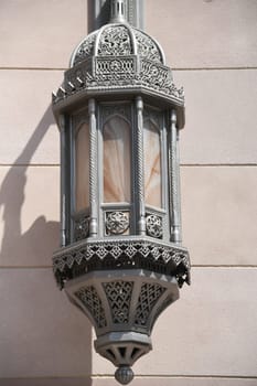 An antique metal street lamp in the Ottoman,oriental style in the city of Muscat in Oman at the Sultan Qaboos Grand Mosque.