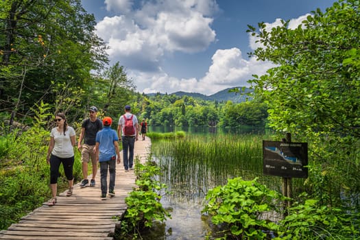 Plitvicka Jezera, Croatia, July 2019 Tourists walking on boardwalk in stunning Plitvice Lakes National Park, a UNESCO World Heritage site