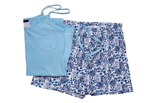 Night gown isolated. Close-up of blue female cotton sexy nightwear summer set of shorts and a top with spaghetty straps isolated on a white background. Fashionable night wear or nighties.