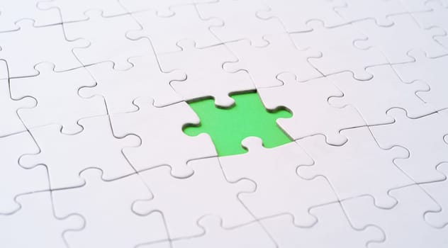 Empty white jigsaw puzzle with missing piece