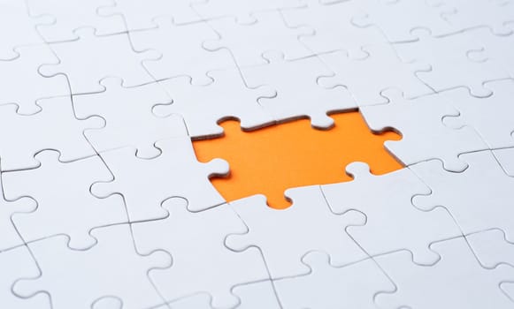 Empty white jigsaw puzzle with missing pieces