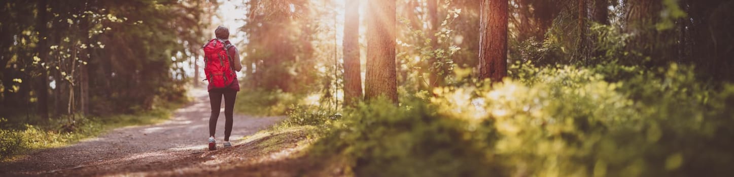 Woman hiking and going camping in nature. Journey at the wildlife area.