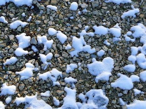 snow residues on pebbles in winter in Germany
