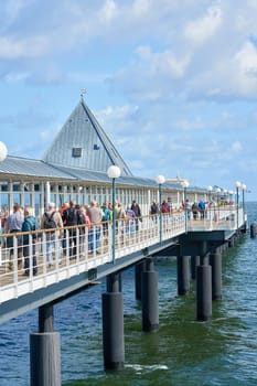 Tourists on the pier of Heringsdorf on the German Baltic coast