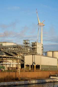 Industrial port in Magdeburg. In the background a wind turbine of the company Enercon.