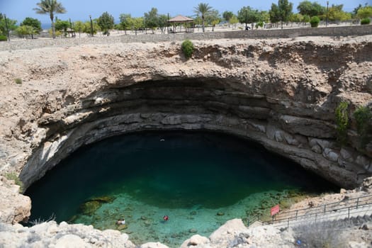 The Hawiyyat Najm or Hawiyat Najm Doline Bimmah Sinkhole is located at the foot of the Hajar Mountains on the Gulf of Oman near the village of Bimma and is connected to the ocean by a cave system