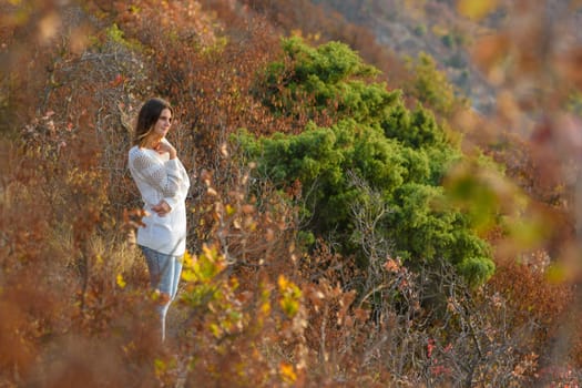 Girl walks in the forest on the mountainside