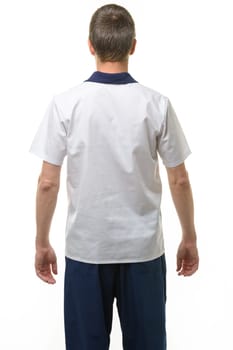 A man in a medical shirt and pants, a view from the back