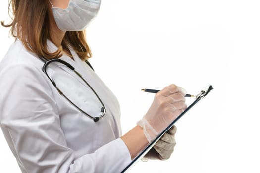 The doctor writes with a pen in a clipboard on a piece of paper