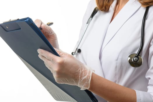 The doctor holds a tablet in his hands and writes down the symptoms of the disease