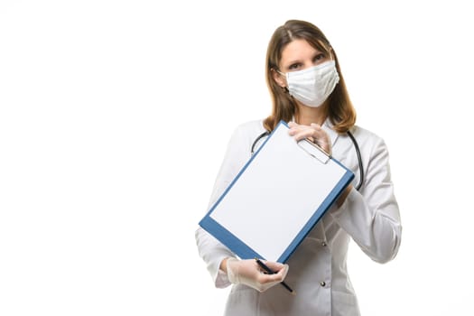 A girl doctor in a mask and gloves holds a tablet with a blank sheet of paper in her hands