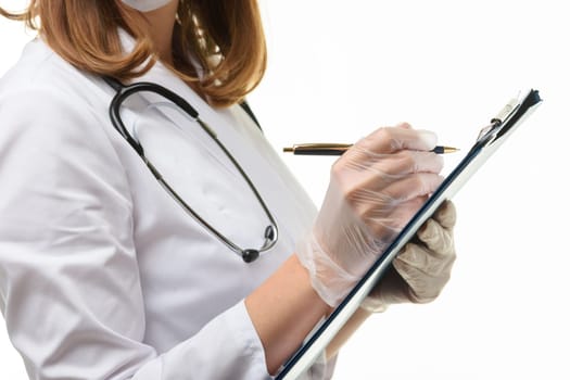Hands of a doctor in gloves writes with a ballpoint pen in a tablet, close-up