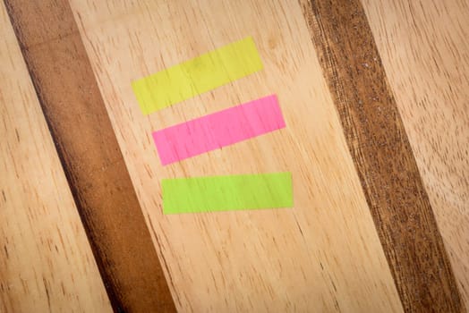 Notes three colours horizontal mix on wood background