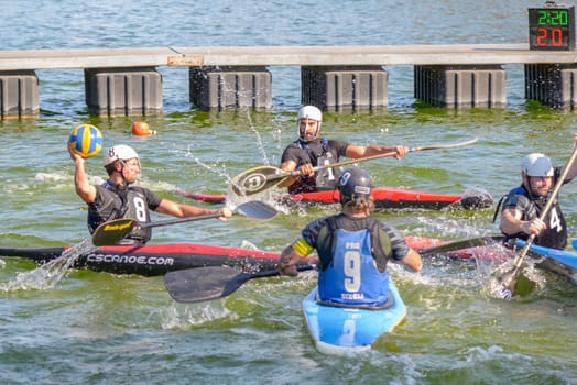 Rome, Italy - March 28, 2015: men playing kayak polo. Kayak polo combines canoeing and ball handling skills with an exciting contact team game, where tactics and positional play are as important as the speed and fitness of the individual athletes.