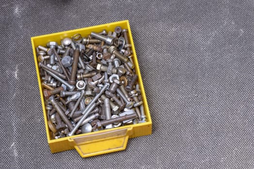 Yellow old box with several screws