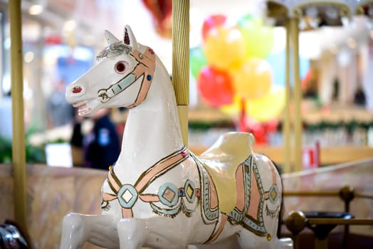 Nice white horse Carousel wit colorful background