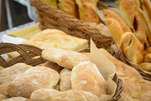 The typical Italian bread for sale to the market, in the baskets of straw