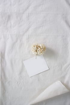 White paper and whit flower on white fabric , decoration background