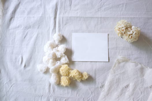 White paper and whit flower on white fabric , decoration background
