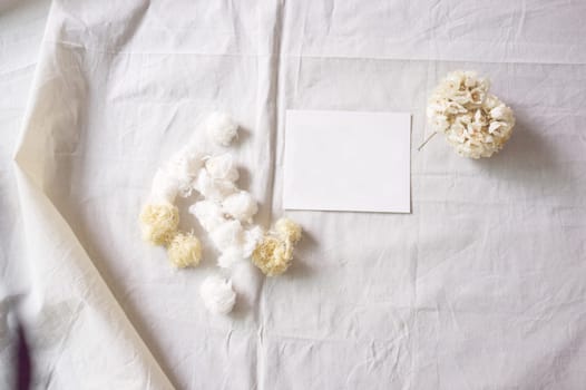 White paper and whit flower on white fabric , decoration background
