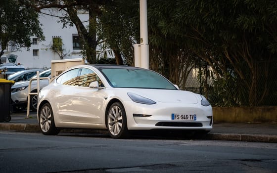 BAYONNE, FRANCE - CIRCA JANUARY 2021: A white Tesla Model 3 parked in the street.
