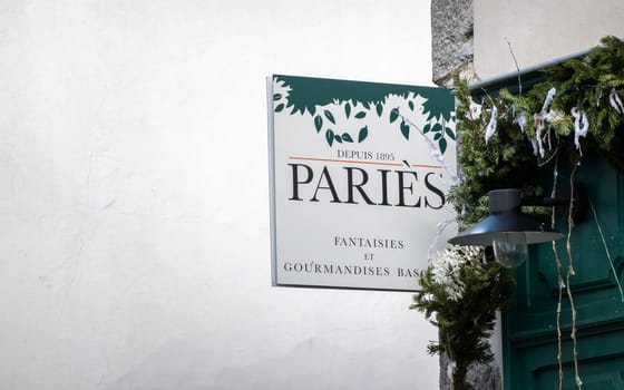 ESPELETTE, FRANCE - CIRCA JANUARY 2021: Paries sign outside shop. Paries is a chocolate, pastry, ice cream and confectionery maker from the French Basque Country.