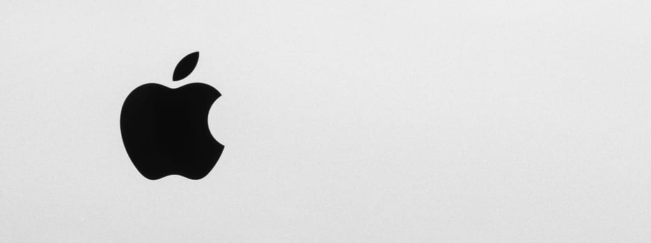 BAYONNE, FRANCE - CIRCA JANUARY 2021: Macro shot of iMac black Apple logo, brushed aluminium texture, high resolution panorama