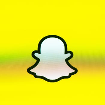 BAYONNE, FRANCE - CIRCA JANUARY 2021: Snapchat ghost logo on yellow background, Apple iPhone screen. Snapchat is a multimedia messaging app developed by Snap Inc.