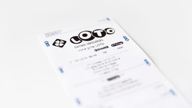 BAYONNE, FRANCE - CIRCA JANUARY 2021: Francaise des Jeux Loto receipt on white background. Loto is one of the games of Francaise des Jeux, France's national lottery operator.