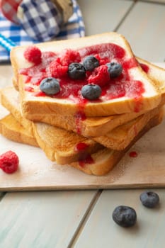 Sandwich toast with berries. French dip sandwich with berries raspberries and blueberries for Breakfast. Vertical image