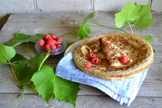 Dessert plate with pancakes and raspberry, pancake week or russian maslenitsa, cuisine of Belarus