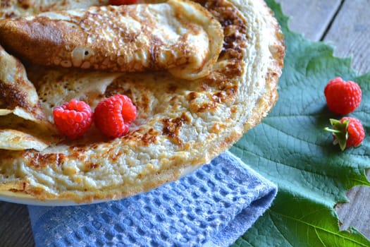 Shrovetide Maslenitsa festival meal. Russian or belarusian pancake blini with raspberry jam, honey, fresh cream and red caviar