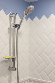 Modern shower on wall rail in modern white bathroom.