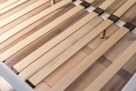 Wooden slats for arthopedic base of double bed. Interior structure of furniture.