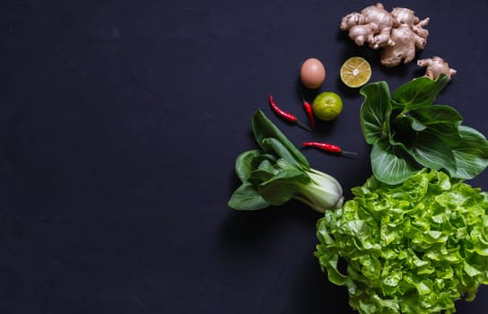 Top view of vegetables and on black background with copy space for insert text. Healthy food concept.