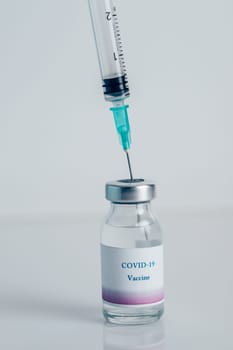 Close-up of a vial with vaccine against COVID-19 and syringe. Bottle with coronavirus vaccine developed for protection against COVID-19. Concept of immunization and biotechnological development.
