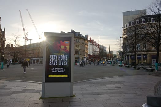 Sheffield, United Kingdom, 12th January, 2021: Fargate region of city center, winter sun shines round digital display of government COVID-19 guidance