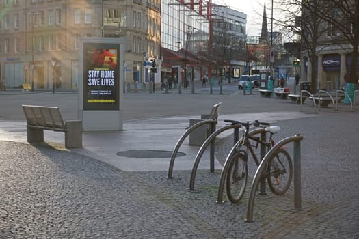 Sheffield, United Kingdom, 12th January, 2021: Fargate region of city, COVID-19 lock down guidance is displayed. Empty bench and bike rack in front