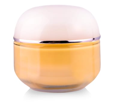 Tonal cream in glass jar on white background closeup