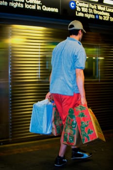 Rear view of a man carrying shopping bags