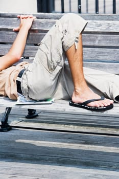 Side profile of a man lying on a bench
