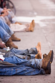 Low section view of a group of people sitting on the street