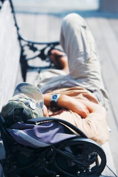 High angle view of a man lying on a bench